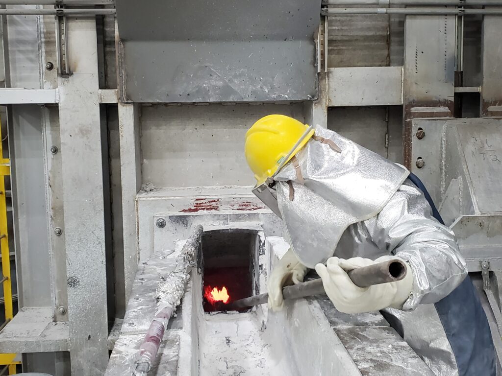 An Ellwood Aluminum employee monitors molten aluminum.