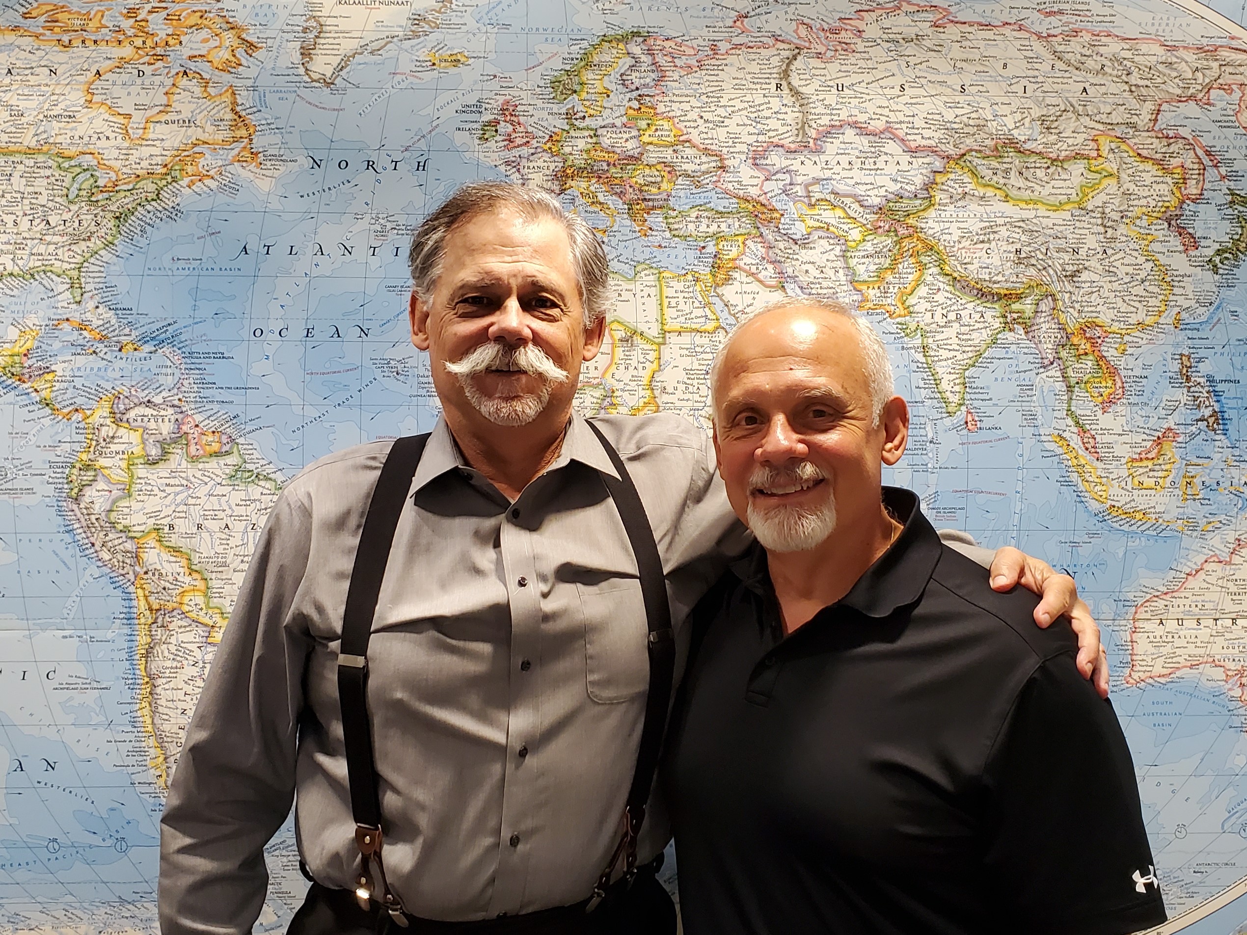Bob Messaros and Mike Conglose of CMF stand in front of a map.