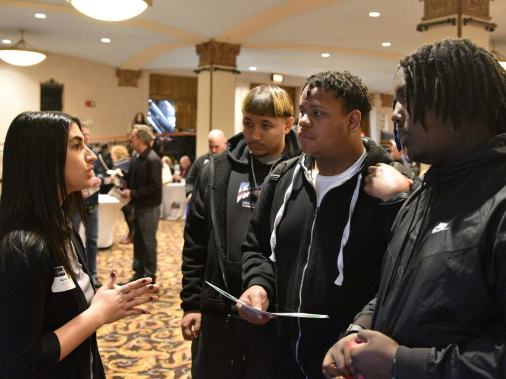 A recruiter talks with students.