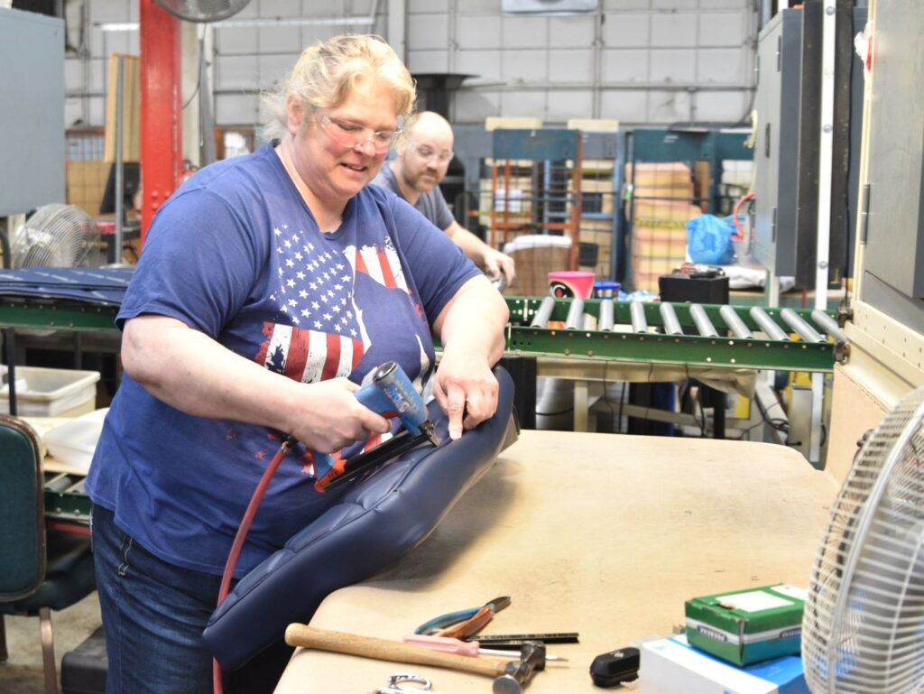 Gasser employee installs rivets into a chair.