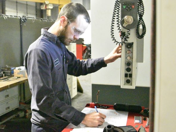 A CNC machine operator works on a project at Dunaway Inc. in Canfield.